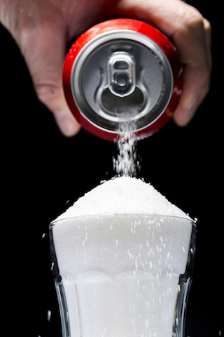 This is a picture of a soda pop and table sugar, one of the foods with refined sugar in it. The picture depicts one of the foods that cause inflammation.