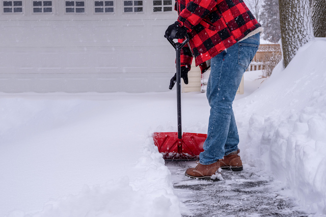 This is a picture of a man shovelling snow to help depict the theme of the blog post called Prevent Back Pain When Shovelling Snow